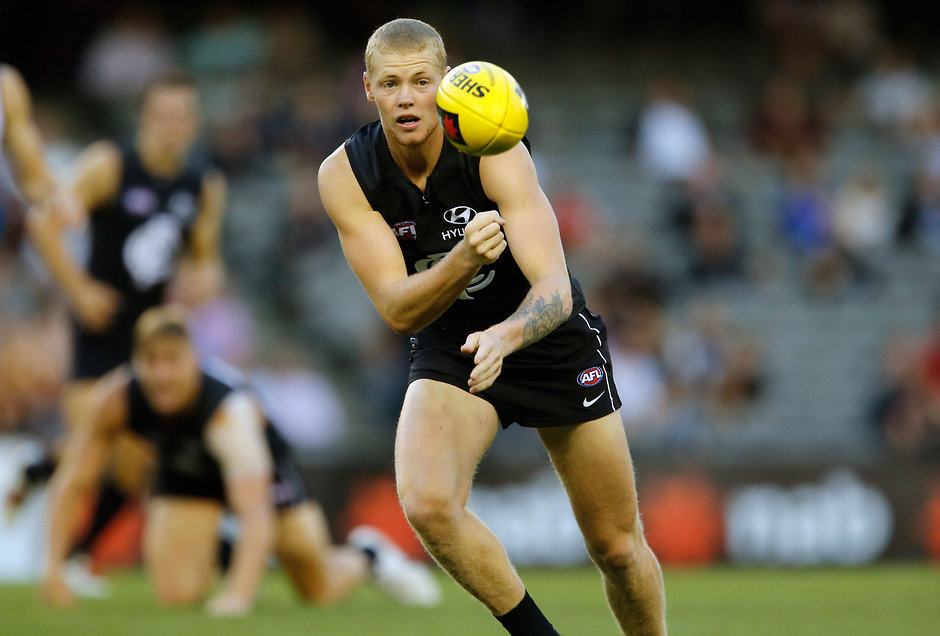 AFL 2014 NAB Challenge - Carlton v Adelaide Carlton's Josh Bootsma handballs during the 2014 NAB Challenge match between the Carlton Blues and the Adelaide Crows at Etihad Stadium on February 24, 2014. (Photo: David Callow/AFL Media)